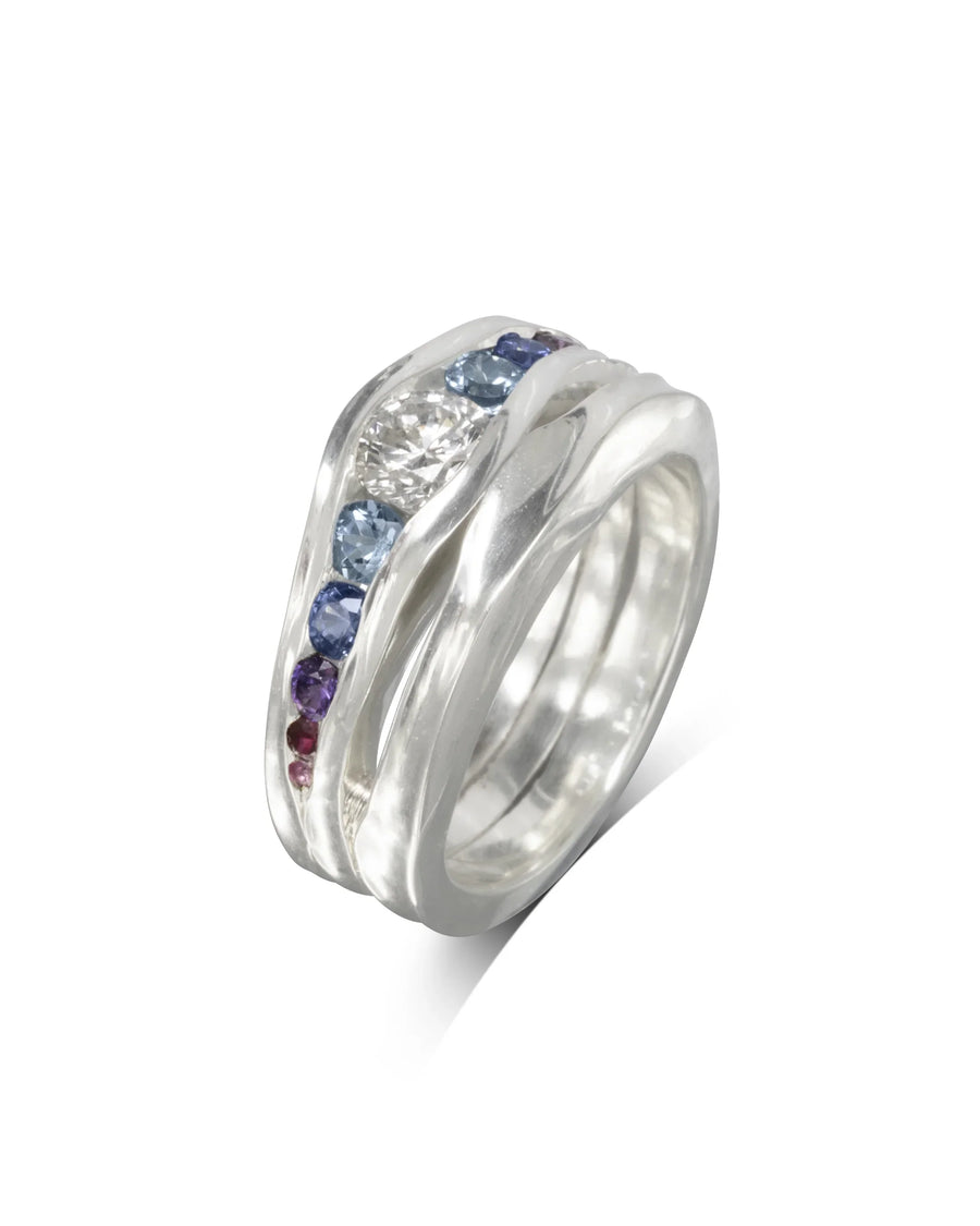 Handmade silver engagement ring with graduated sapphires and central diamond