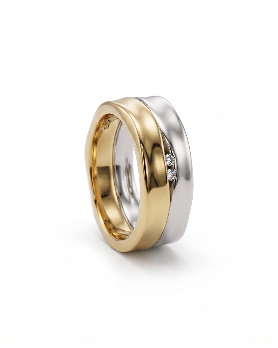 Wide two-colour gold eternity ring with two diamonds.