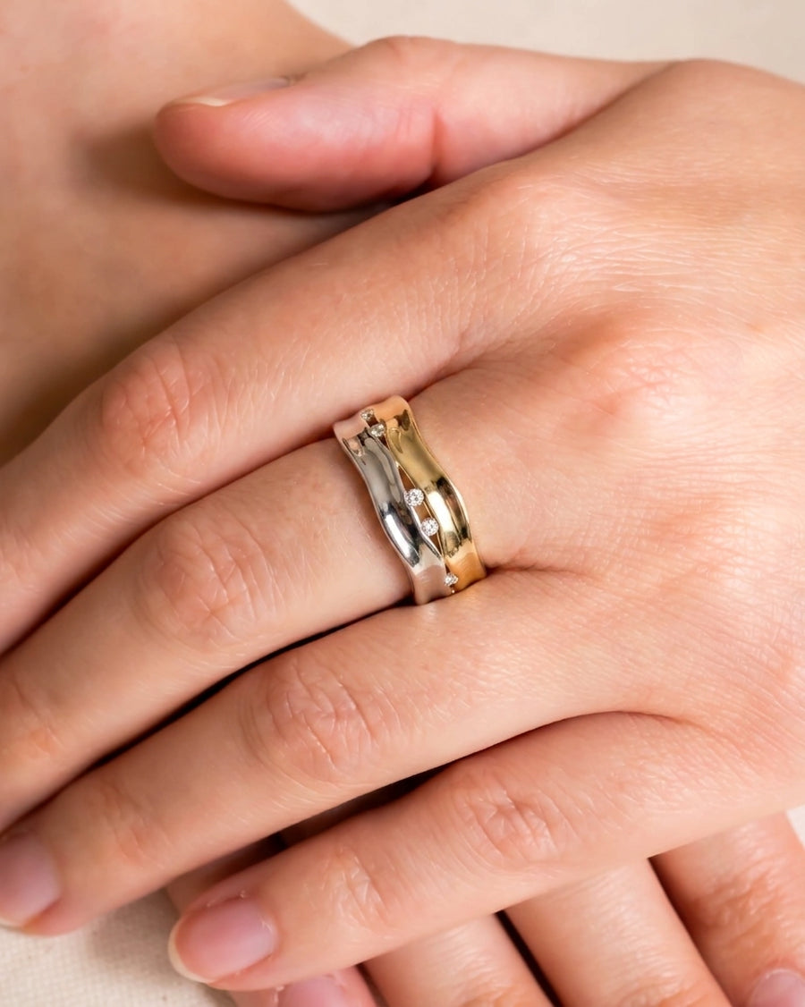 Two-colour gold and silver wide eternity ring with diamonds.