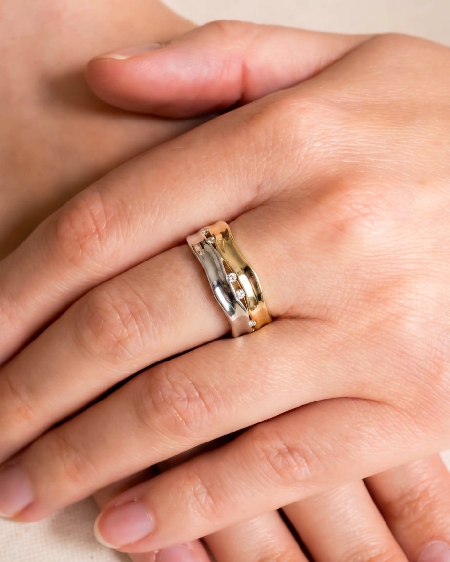 Two-colour gold and silver wide eternity ring with diamonds.