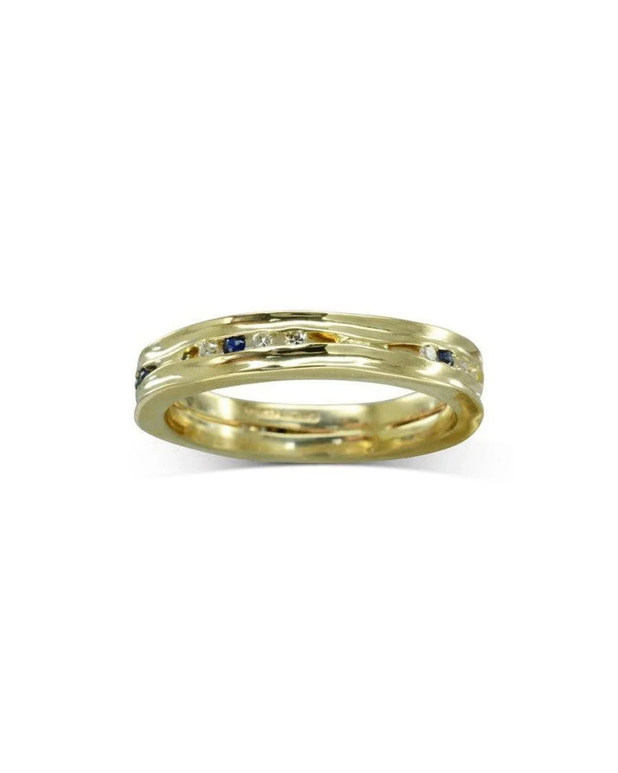 Narrow yellow gold ring with scattered diamonds and blue sapphires.