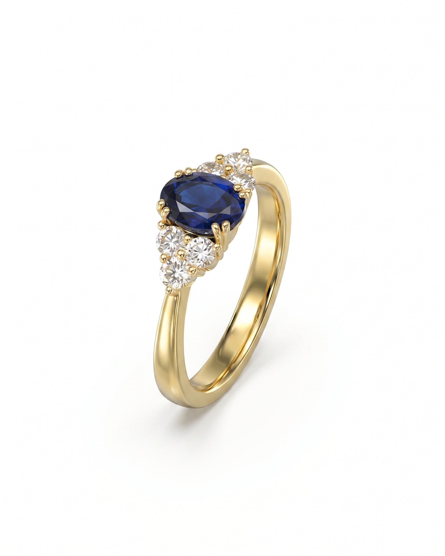 Gold engagement ring featuring an oval blue sapphire flanked by clusters of round diamonds in a trefoil design.