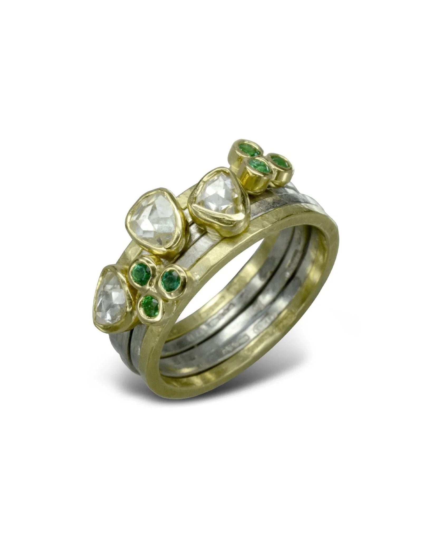 Gold and silver stacking rings with rough diamonds and green gemstone clusters