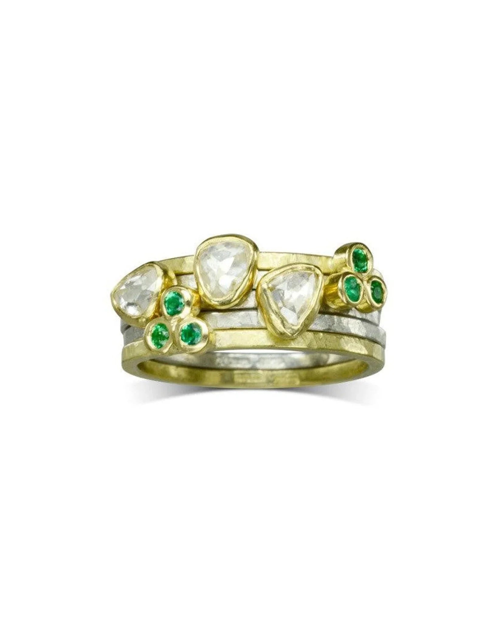 Gold and silver stacking rings with rough diamonds and green gemstones, organic design