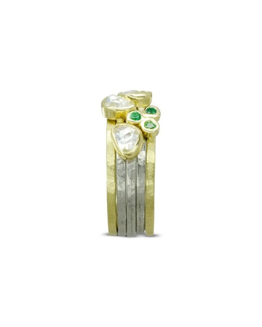 Gold and silver stacking rings set with rough diamonds and green gemstone accents