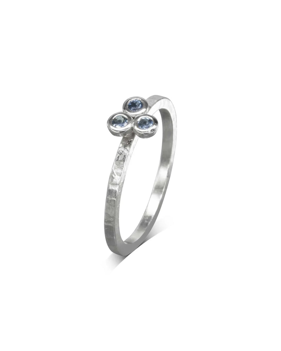 Silver ring with three round blue gemstones in a trefoil design.