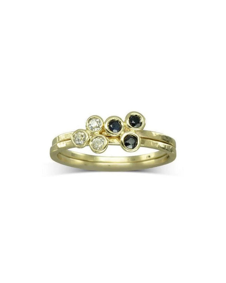 Gold stackable ring with trefoil design, featuring diamonds and black gemstones.