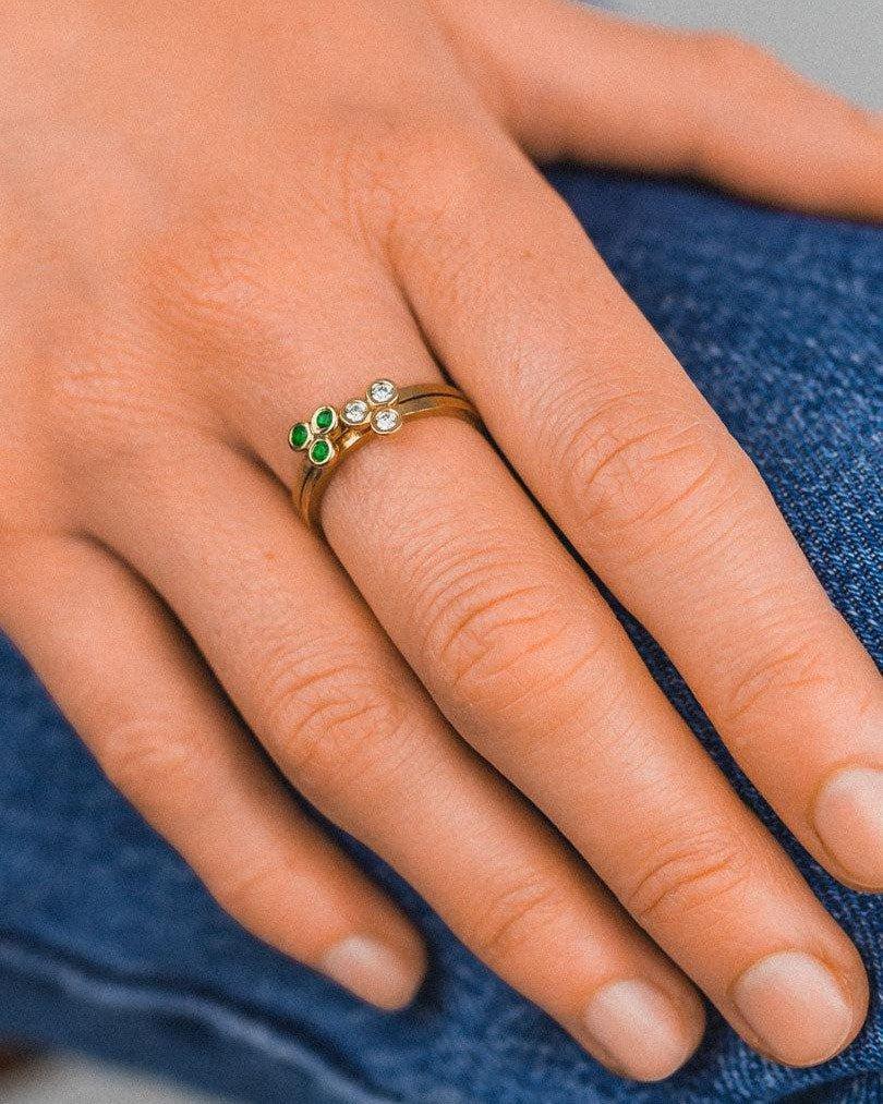 9ct yellow gold stackable ring with emerald and diamond trefoil designs.
