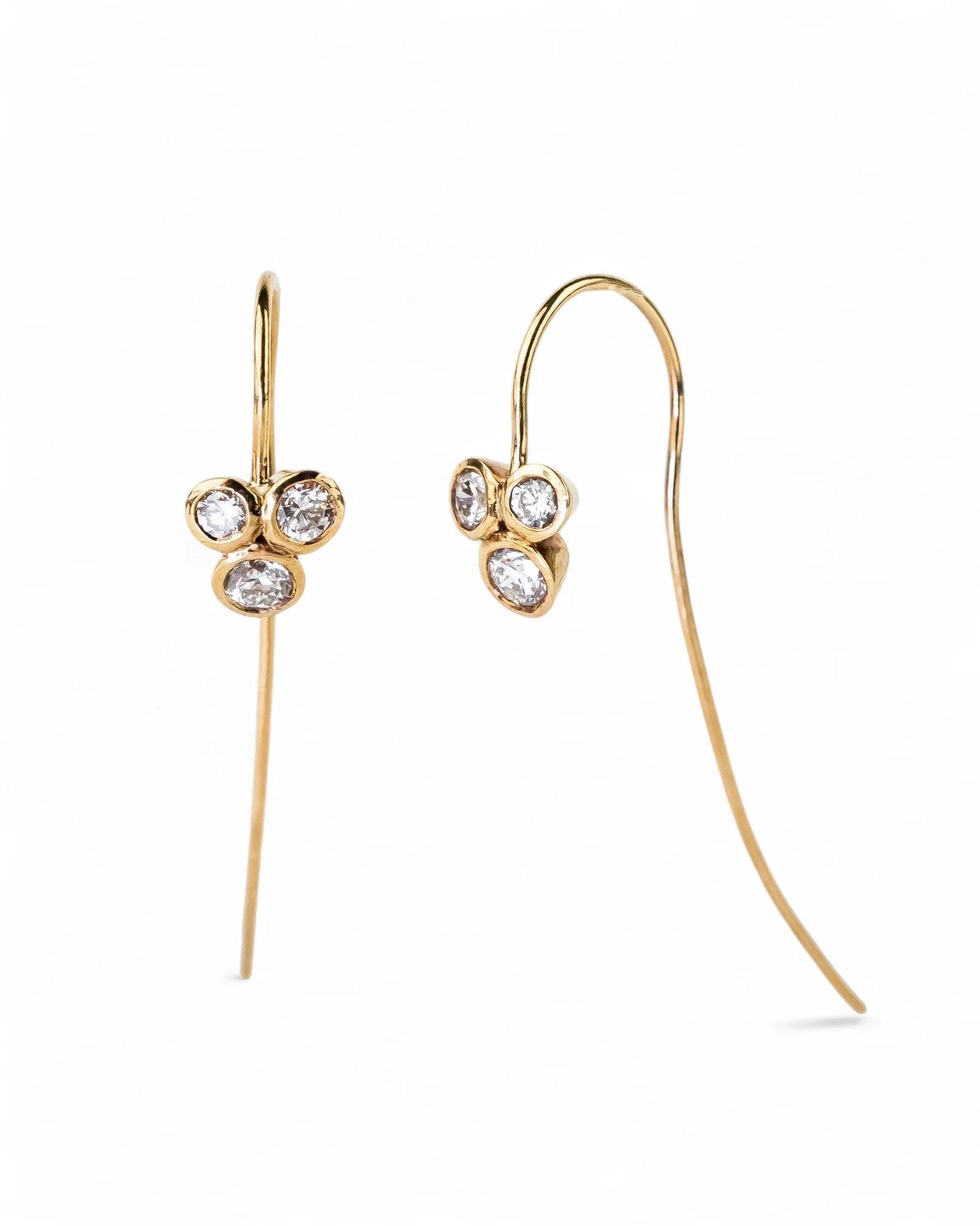 Yellow gold hook earrings with trefoil clusters of round diamonds on white background