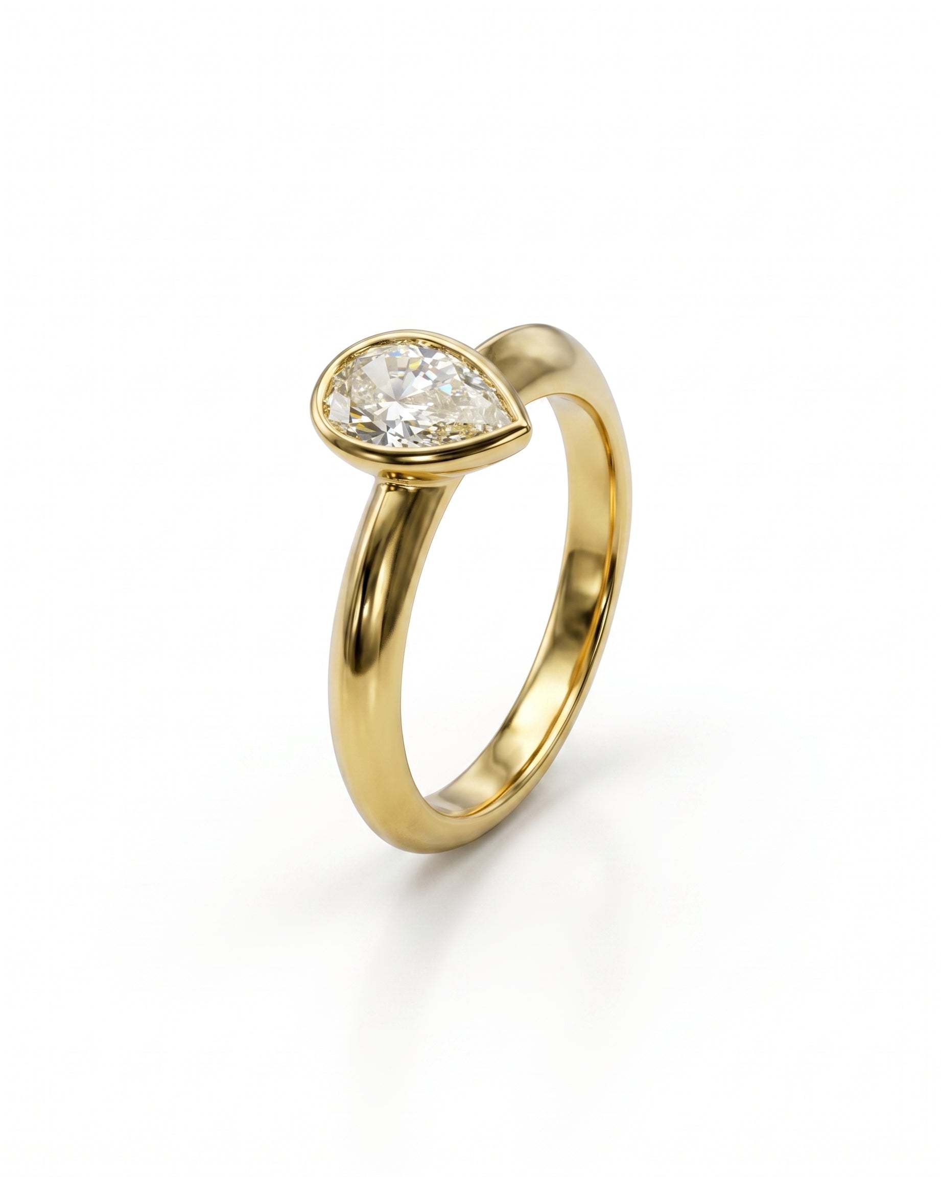 Gold solitaire engagement ring with a pear cut diamond.
