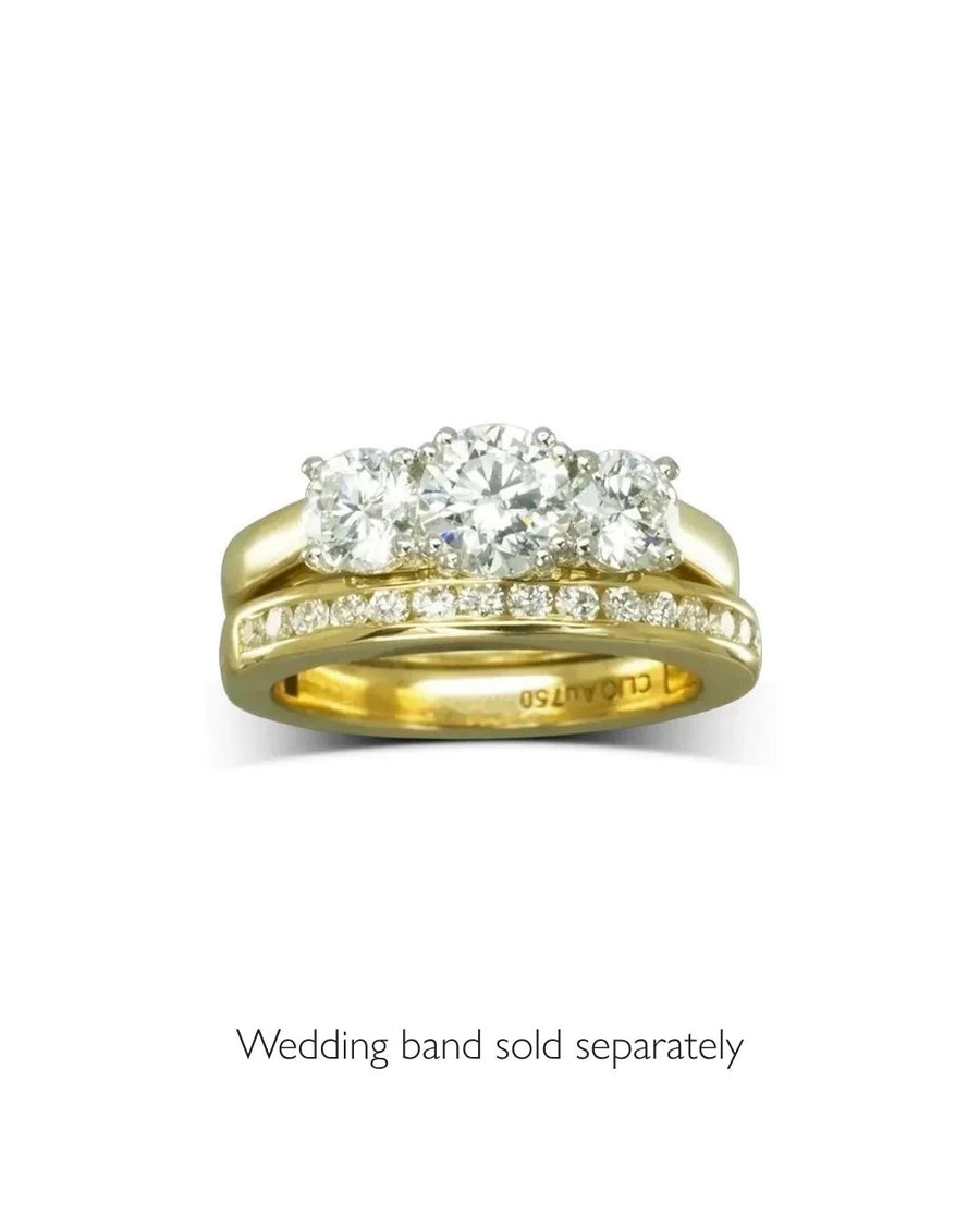 Yellow gold engagement ring with three large round diamonds and a pavé diamond band.