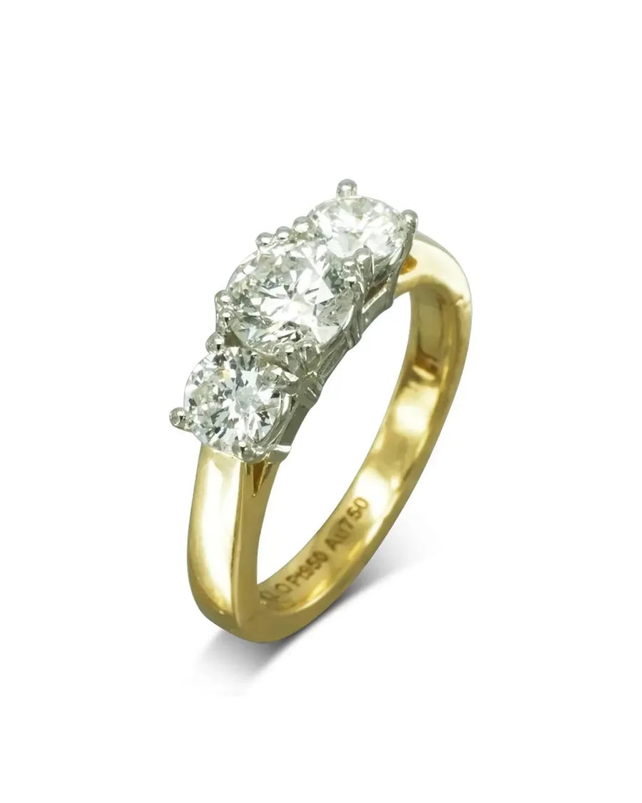 Yellow gold engagement ring with three round brilliant diamonds.