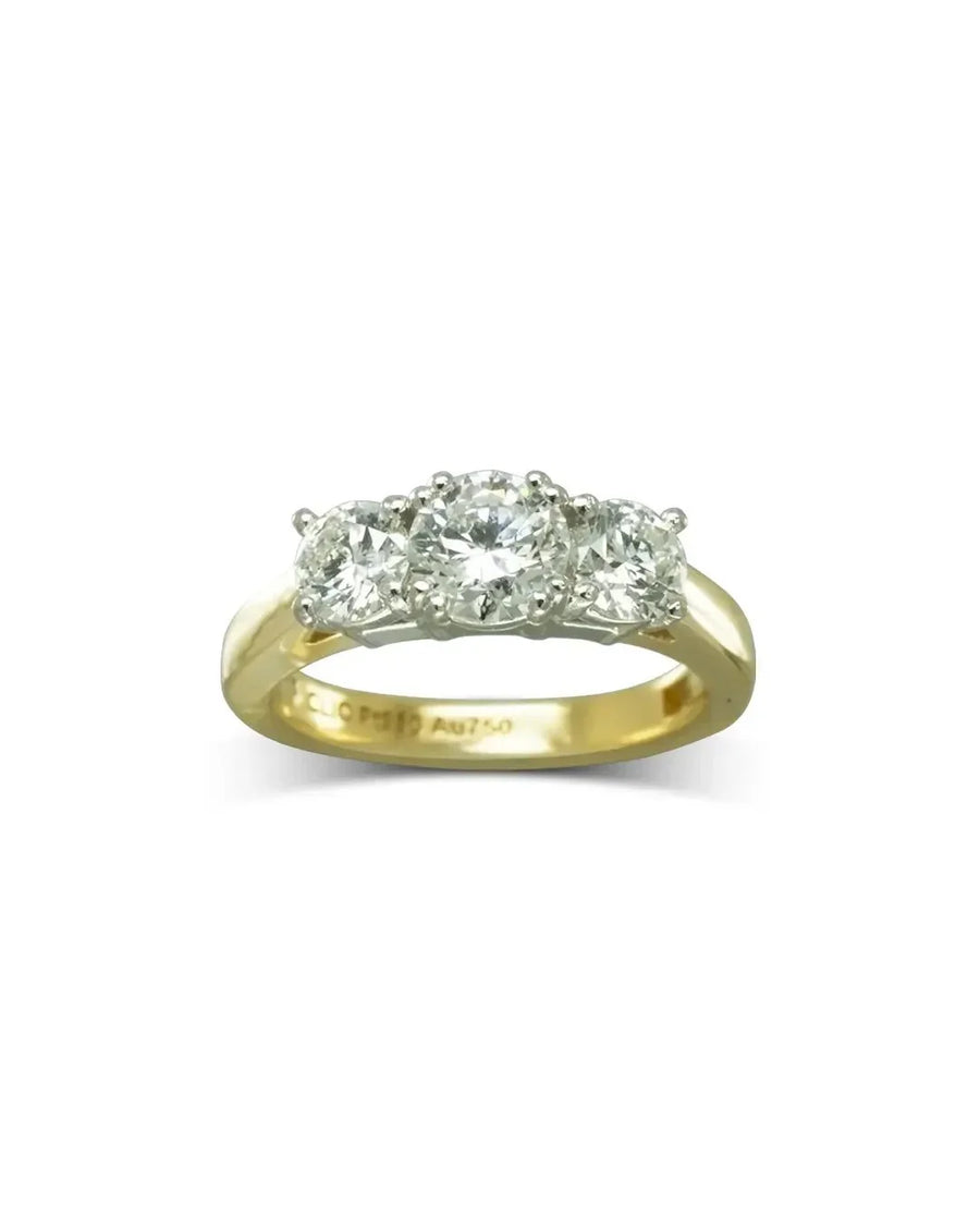 Yellow gold engagement ring with three round brilliant diamonds.