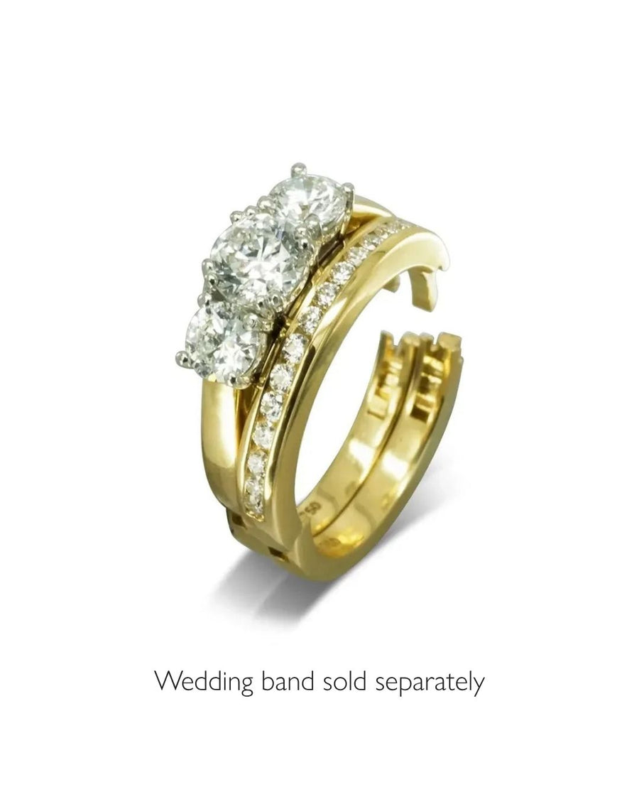 Yellow gold hinged engagement ring with three large diamonds and pavé diamonds.