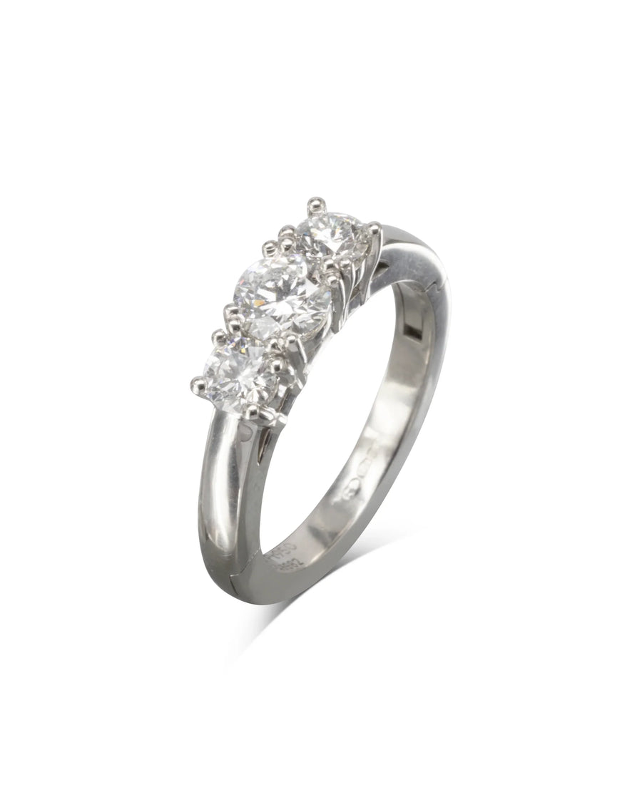Platinum hinged engagement ring with three round brilliant diamonds.