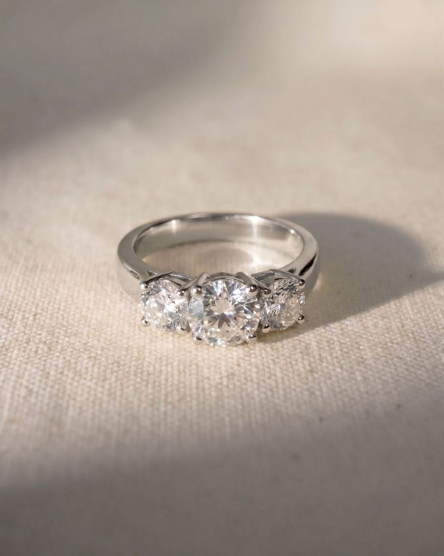 Platinum trilogy engagement ring with three round diamonds.