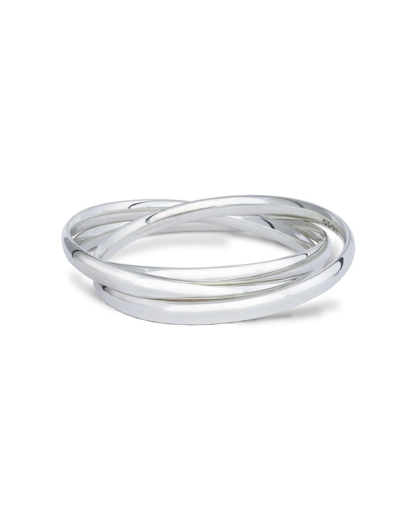 Triple solid silver bangle with overlapping bands on a white background
