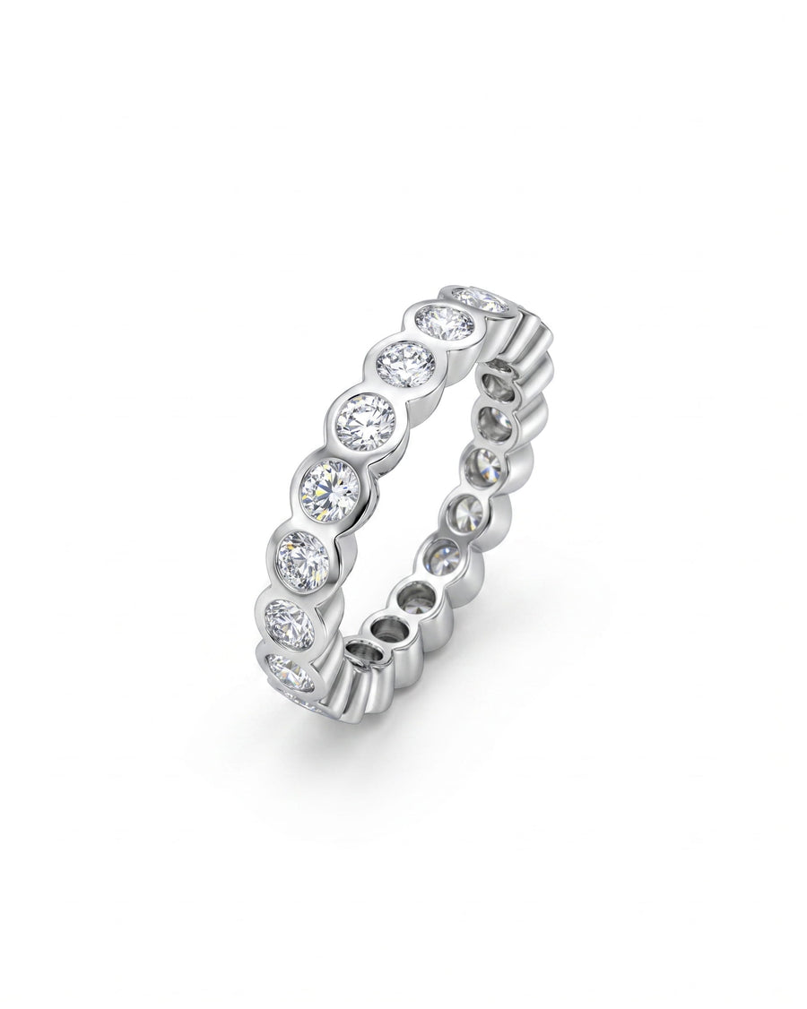 Platinum full eternity ring with bezel-set round diamonds.