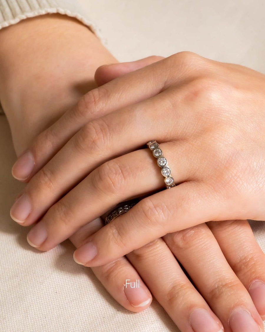 Platinum tube form full eternity ring with round diamonds.