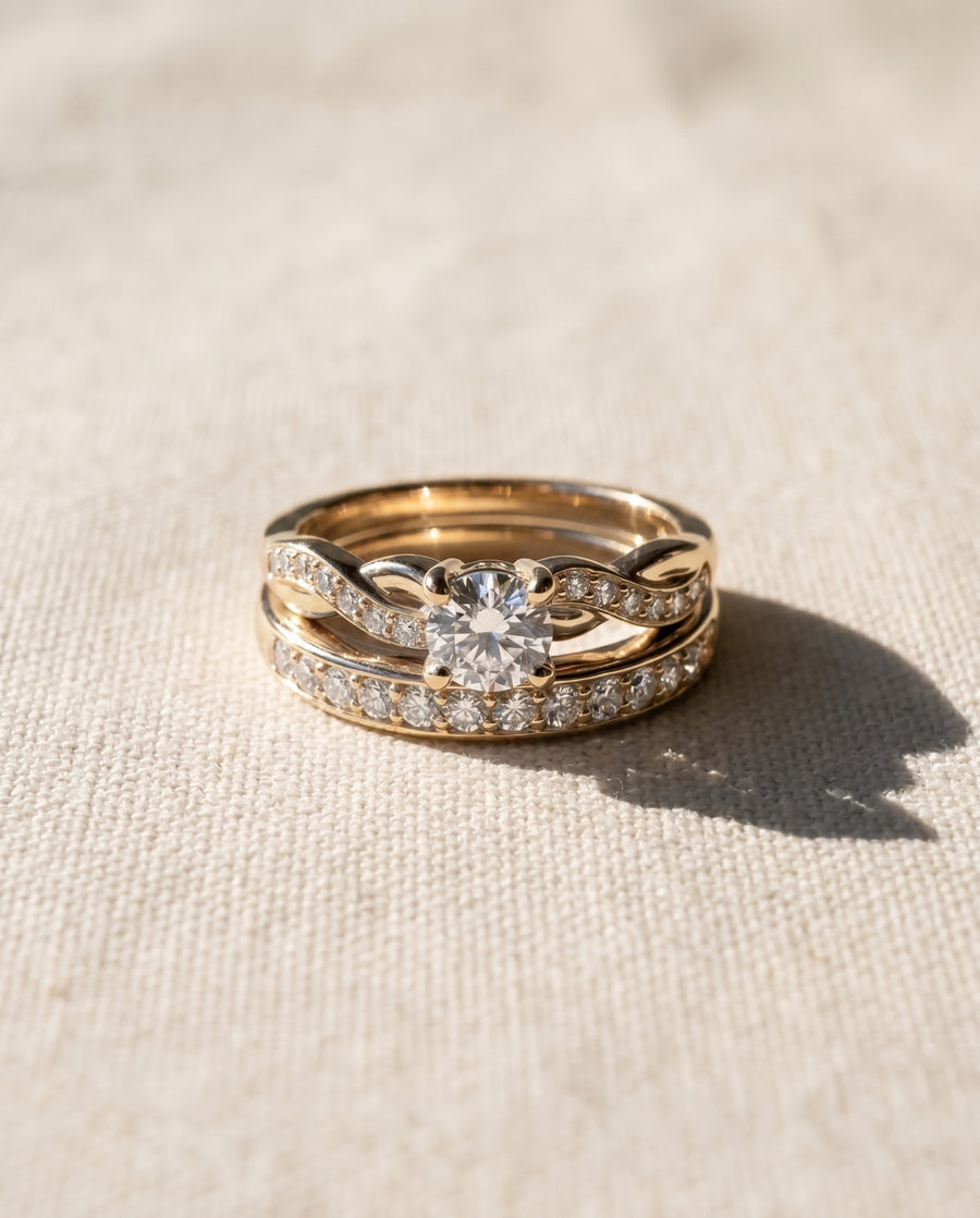 18ct yellow gold twist engagement ring and wedding band set with diamonds.