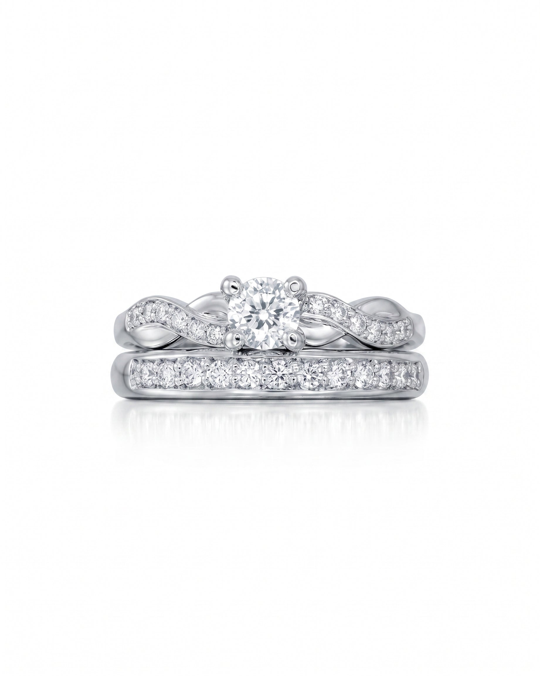 White gold twist engagement ring with a round diamond and matching diamond wedding band.