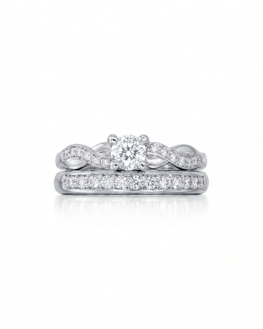 White gold twist engagement ring with a round diamond and matching diamond wedding band.
