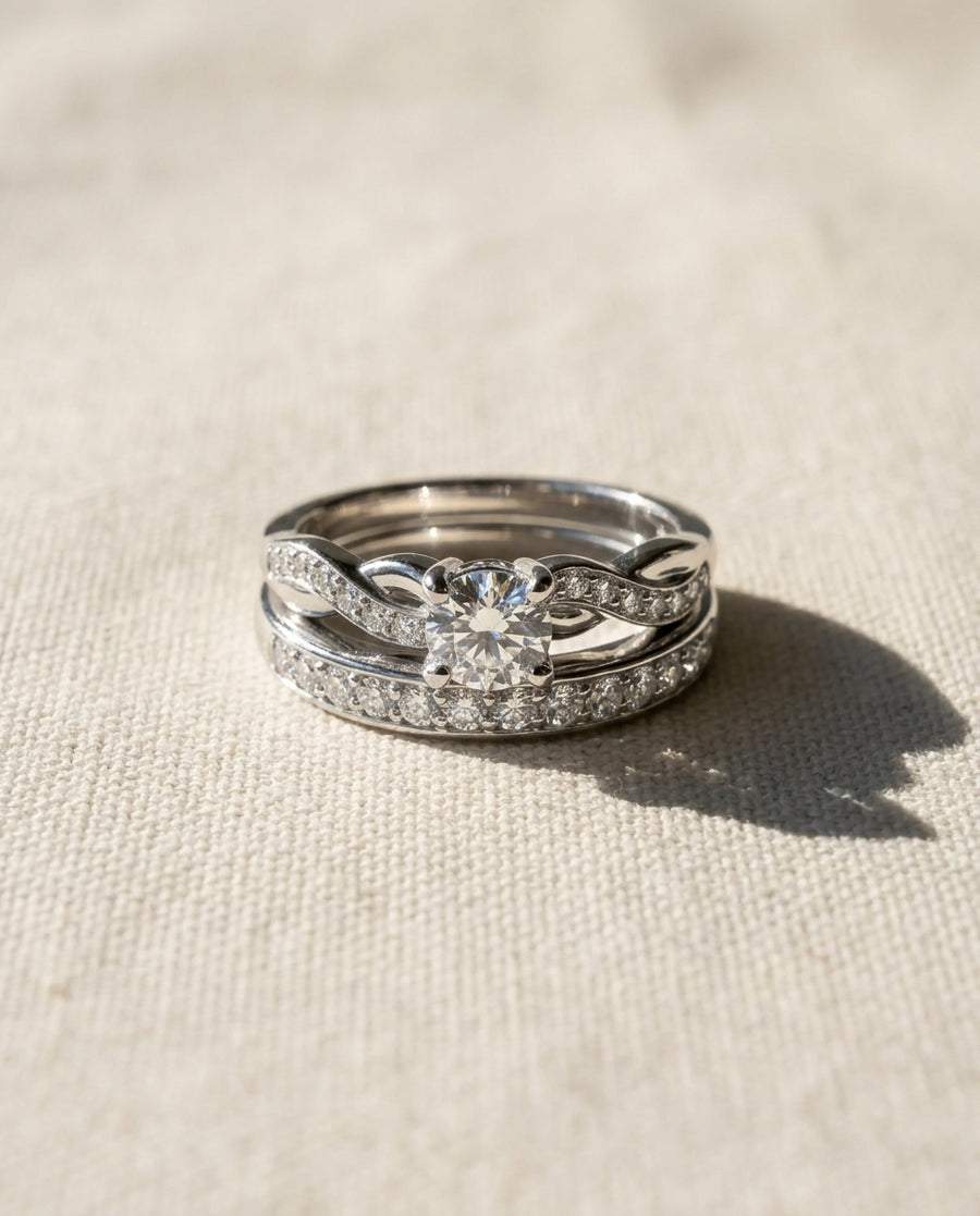 Platinum twist engagement ring and wedding band set with diamonds.