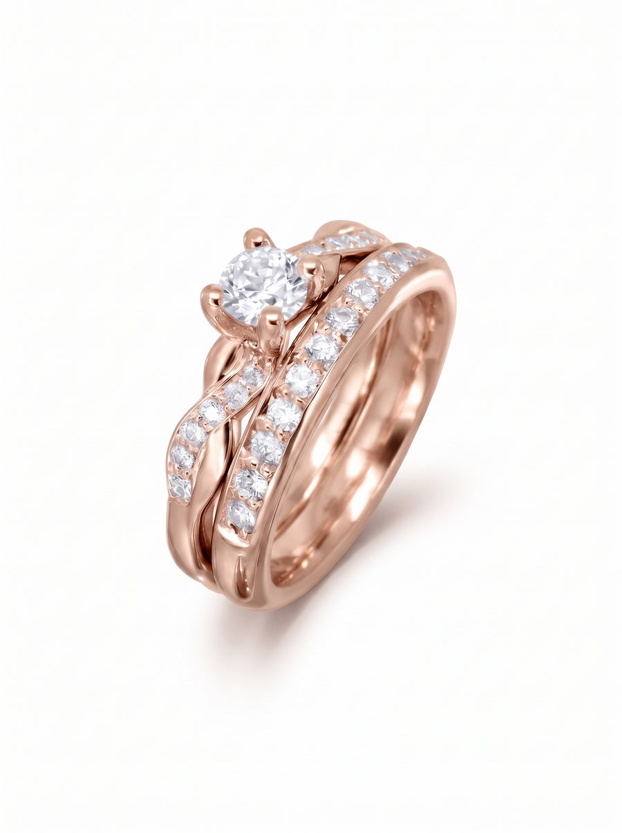 Rose gold engagement ring and wedding band set with a twisted design and round diamond accents.