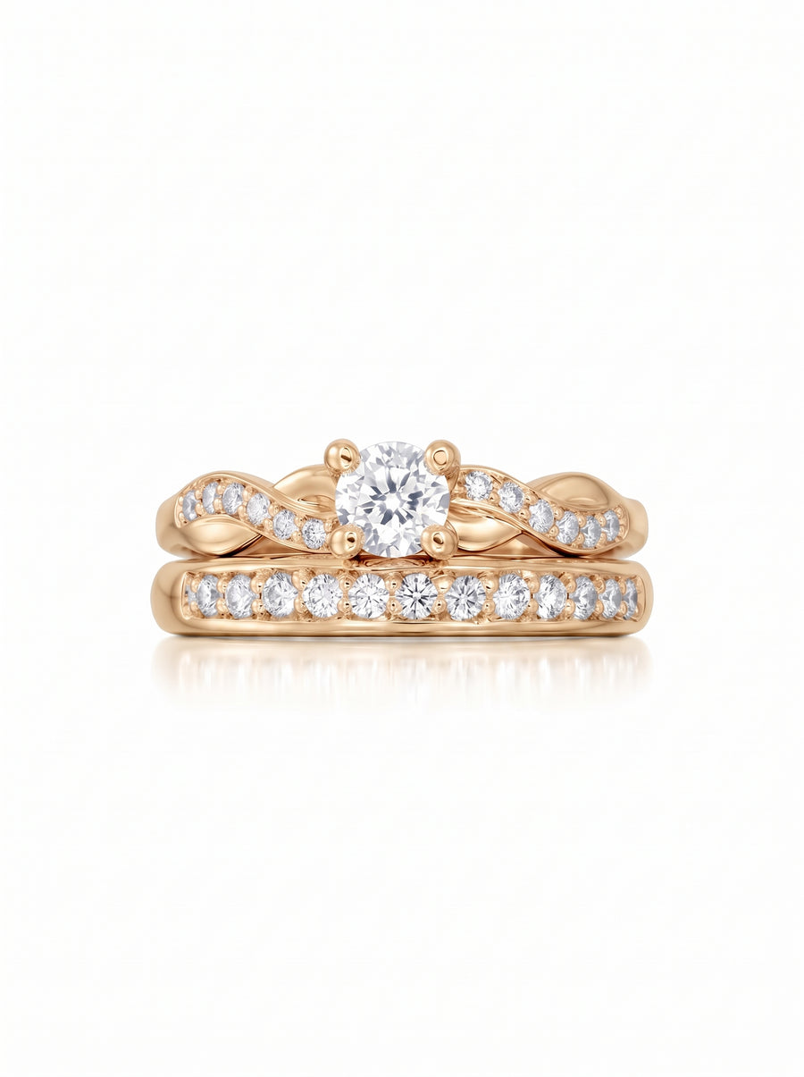 Rose gold engagement ring and wedding band set with a twisted design and round diamond accents.