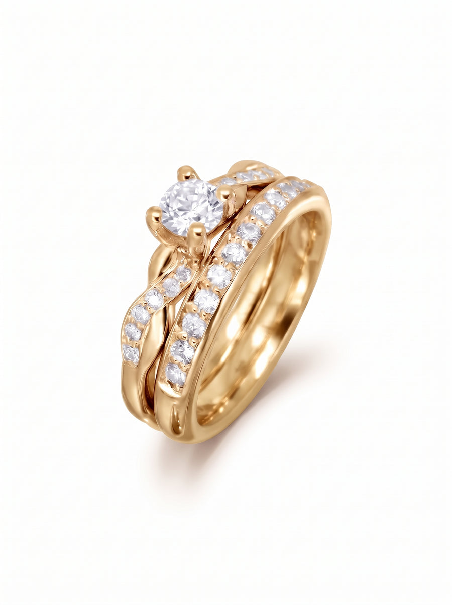 Gold twist engagement ring and wedding band set with round diamonds on a white background.