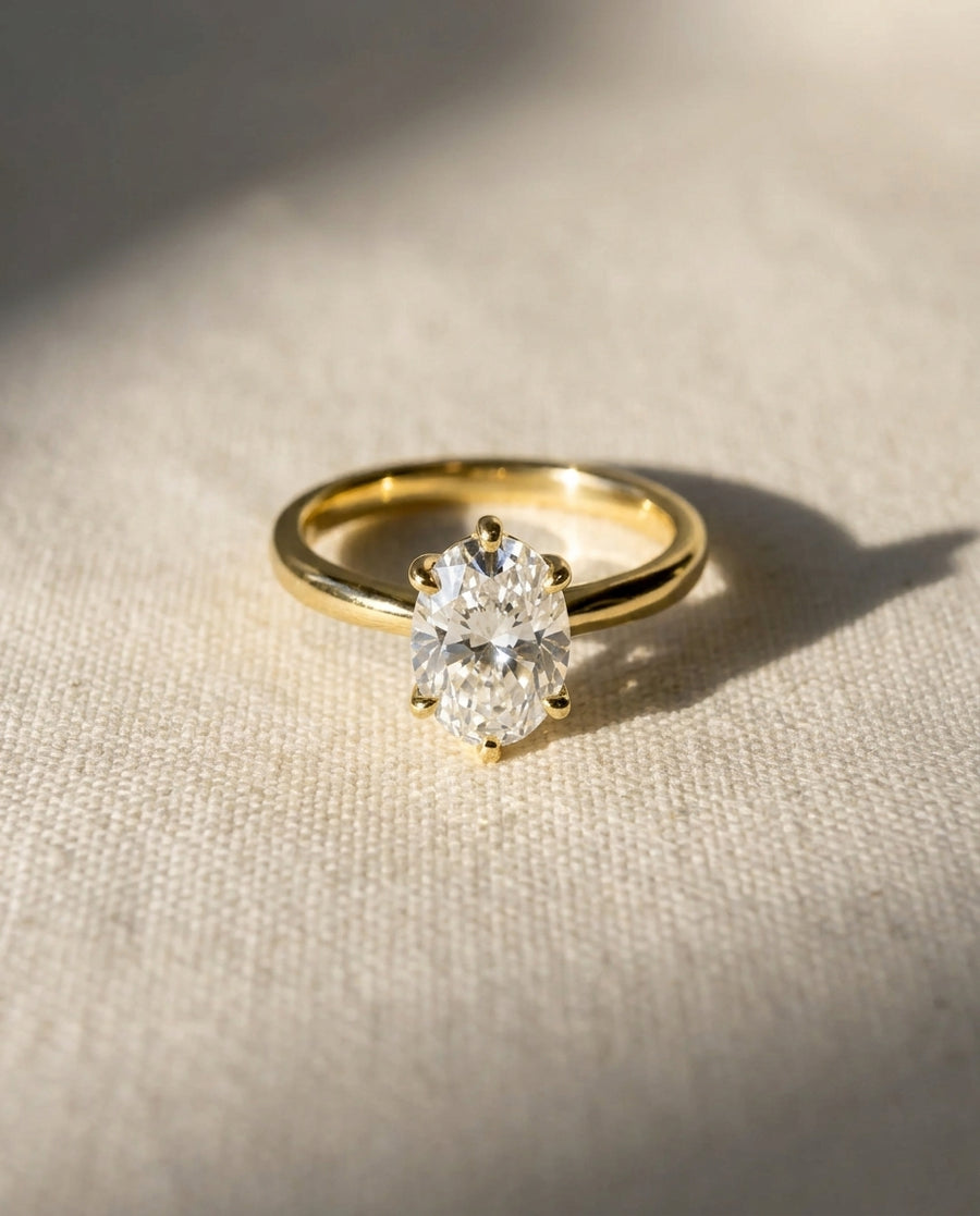 18ct yellow gold engagement ring with a 0.75ct oval diamond.