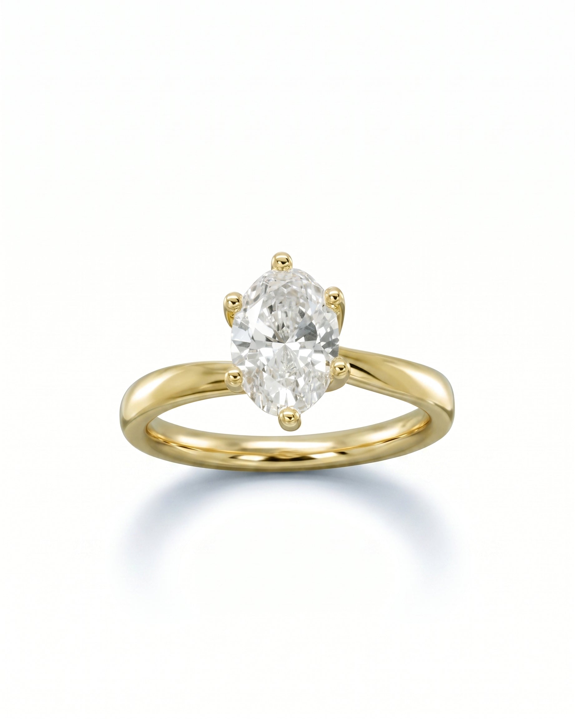 Yellow gold engagement ring with a six-prong set oval diamond.