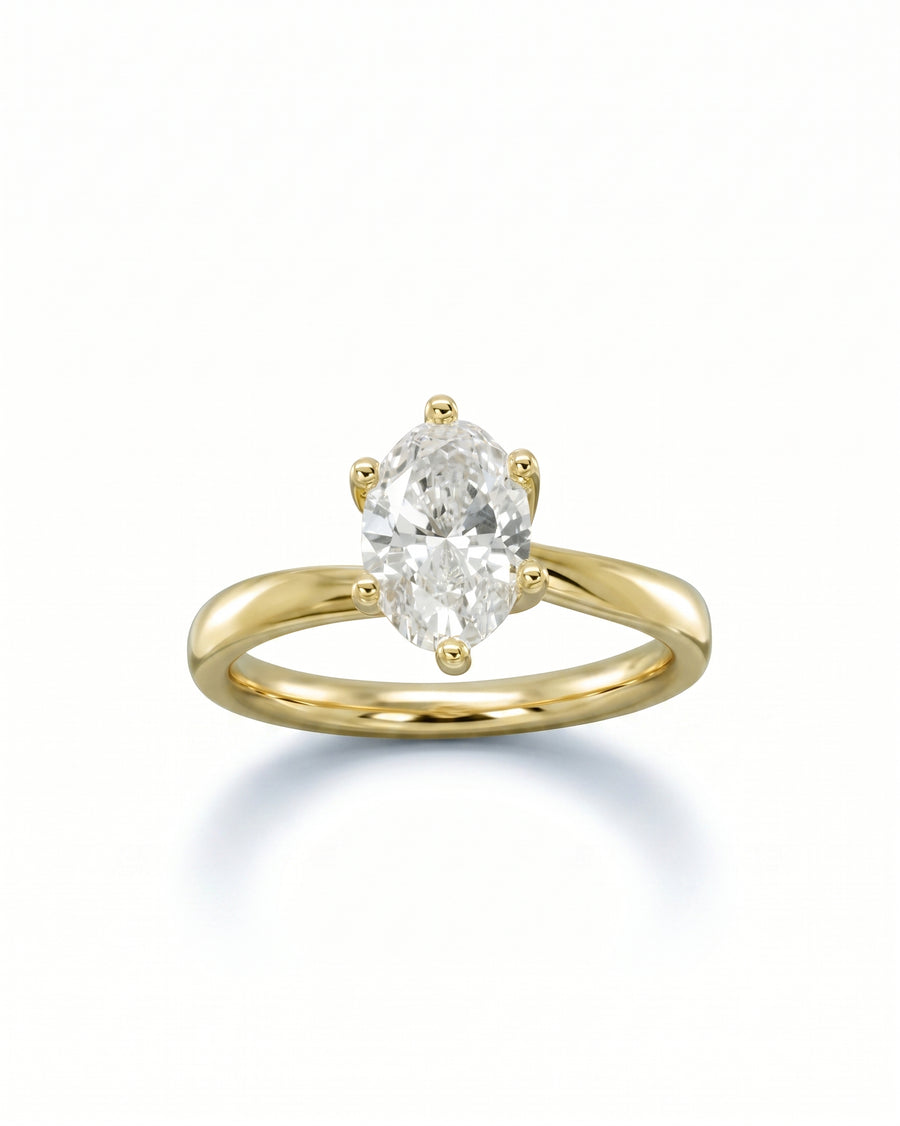 Yellow gold engagement ring with a six-prong set oval diamond.