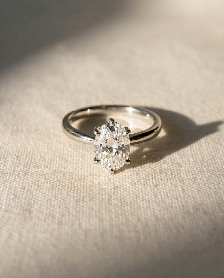 Platinum engagement ring with an oval diamond in a six-prong setting.