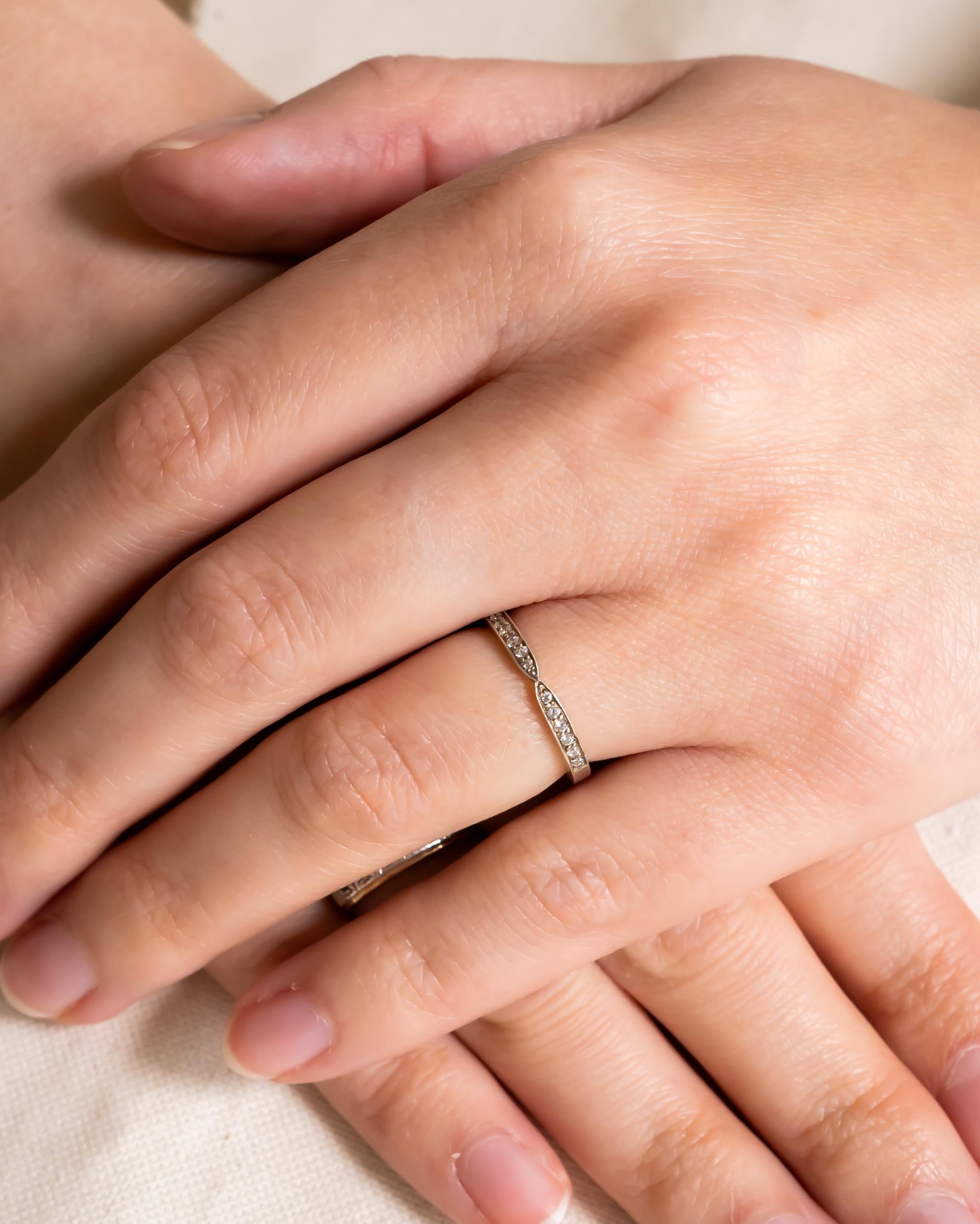 Platinum twist pavé set diamond ring on a hand.