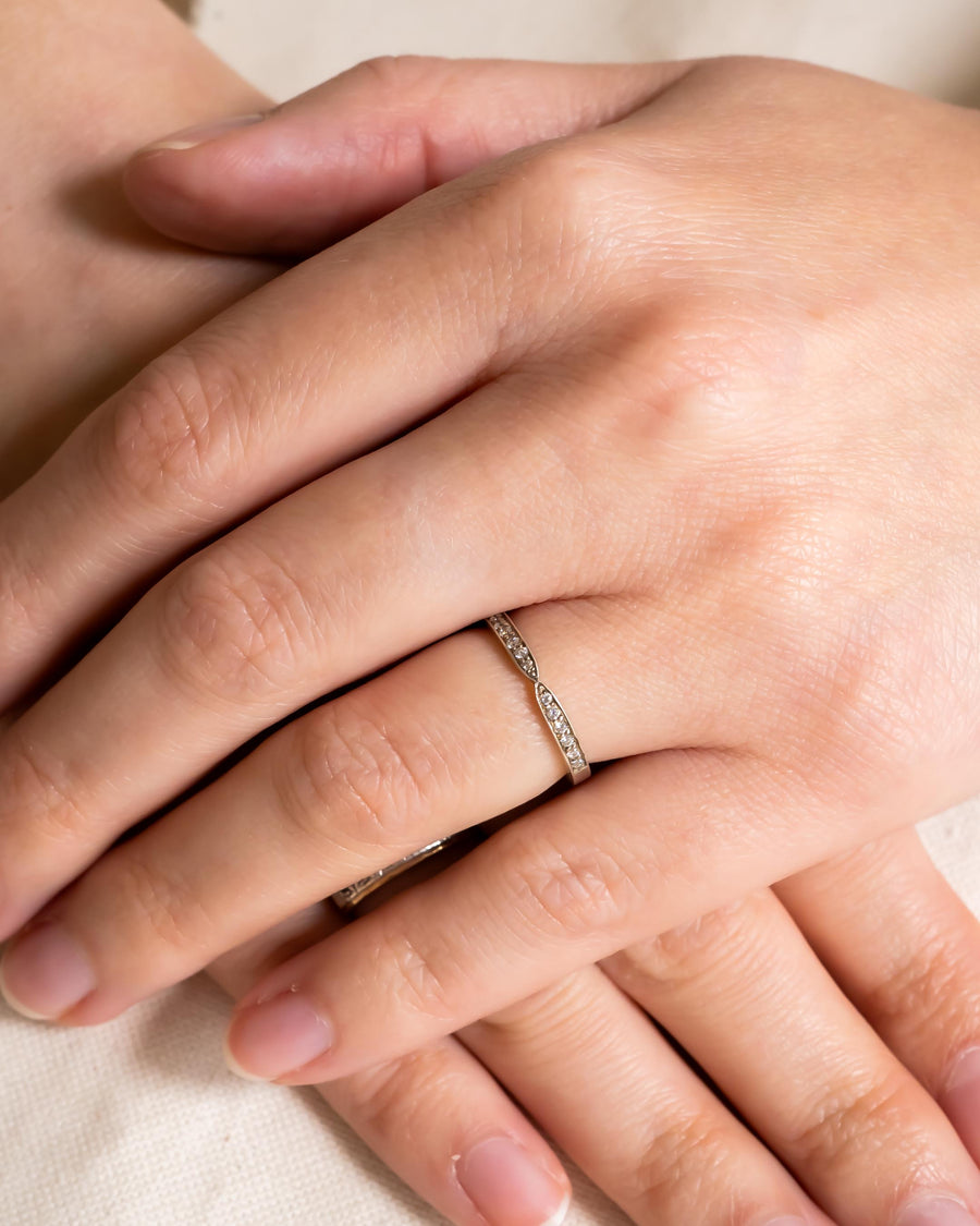 Platinum twist pavé set diamond ring on a hand.