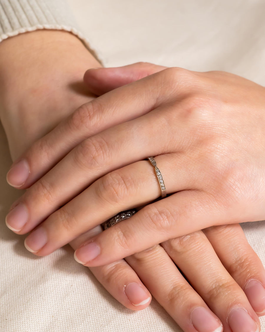 Platinum twist pavé set diamond ring on a hand.