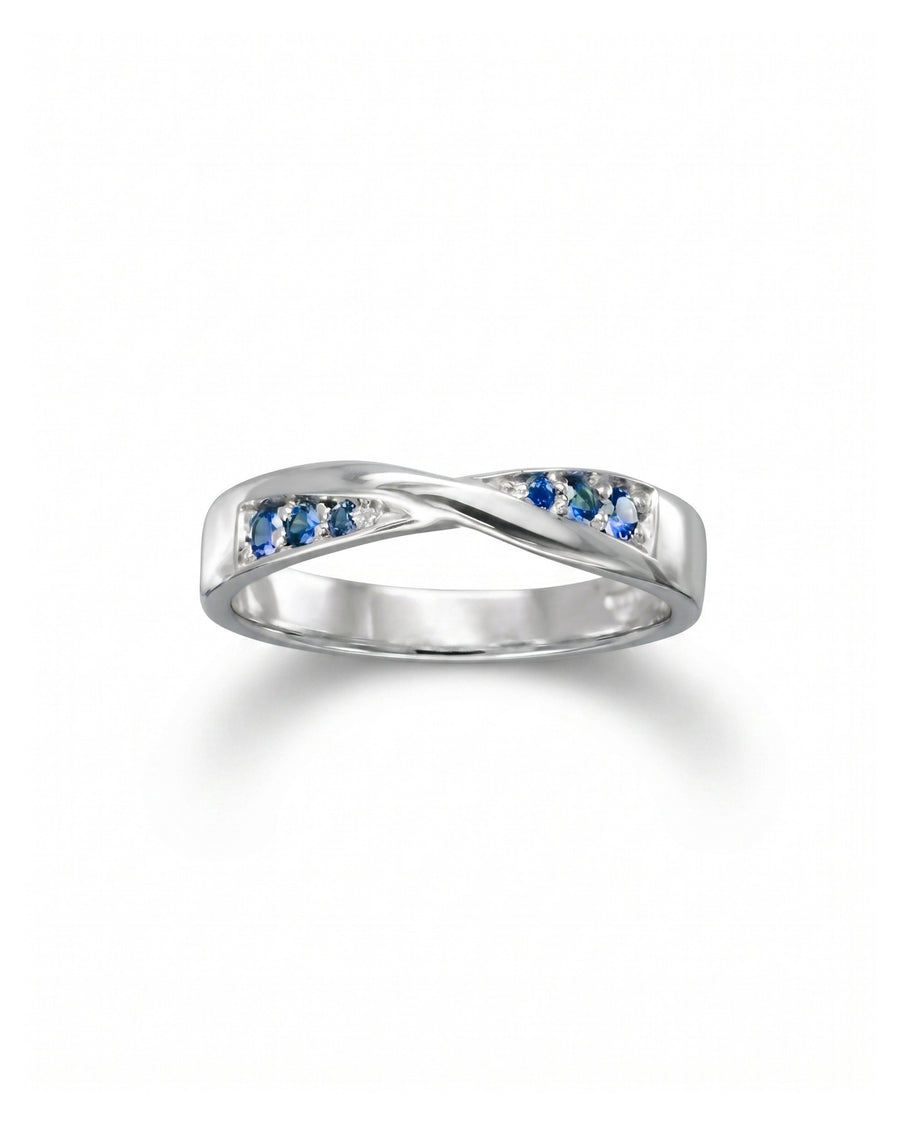Silver twist ring with blue sapphires and small diamonds.