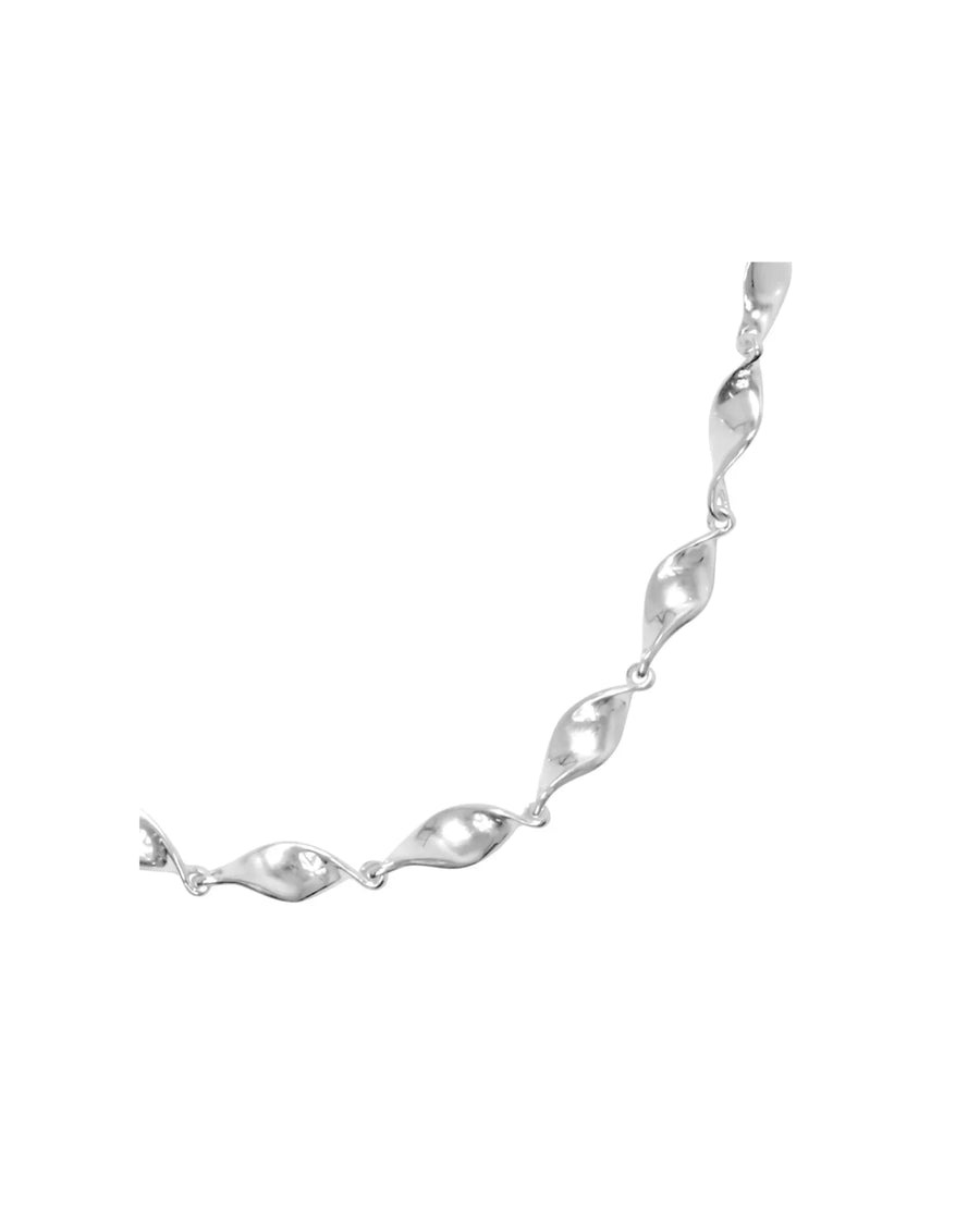 Handmade silver twist necklace with organic, sculpted links against a white background.