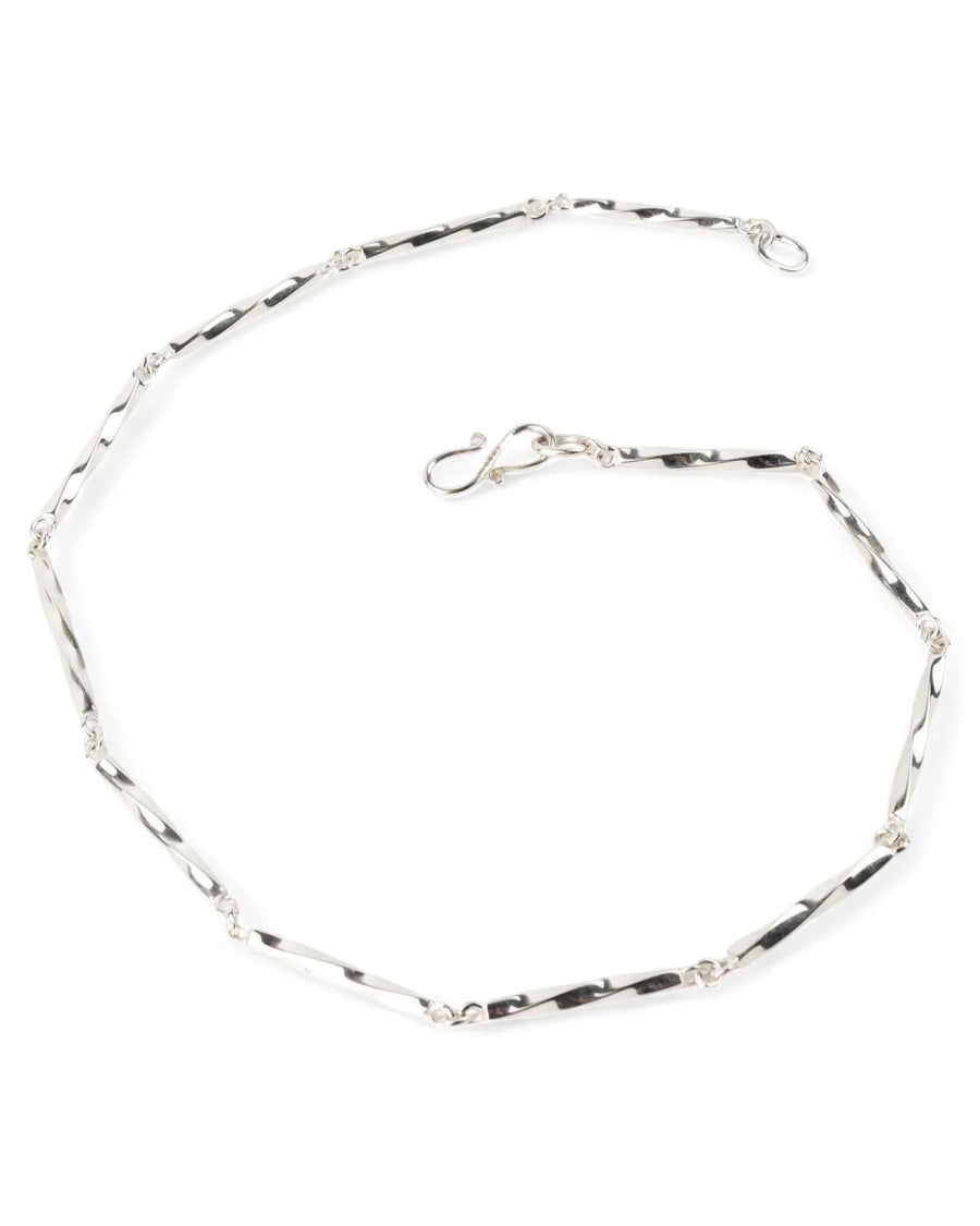 Twisted silver chain necklace with elongated links and hook clasp on white background