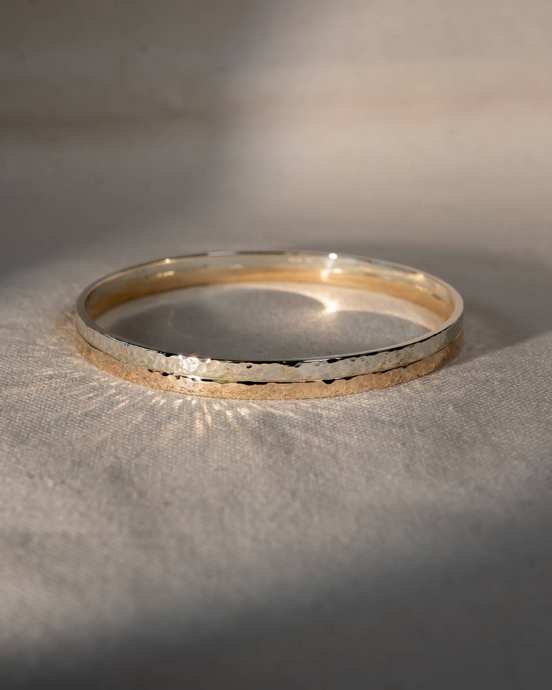 Two tone 9ct gold hammered bangle.