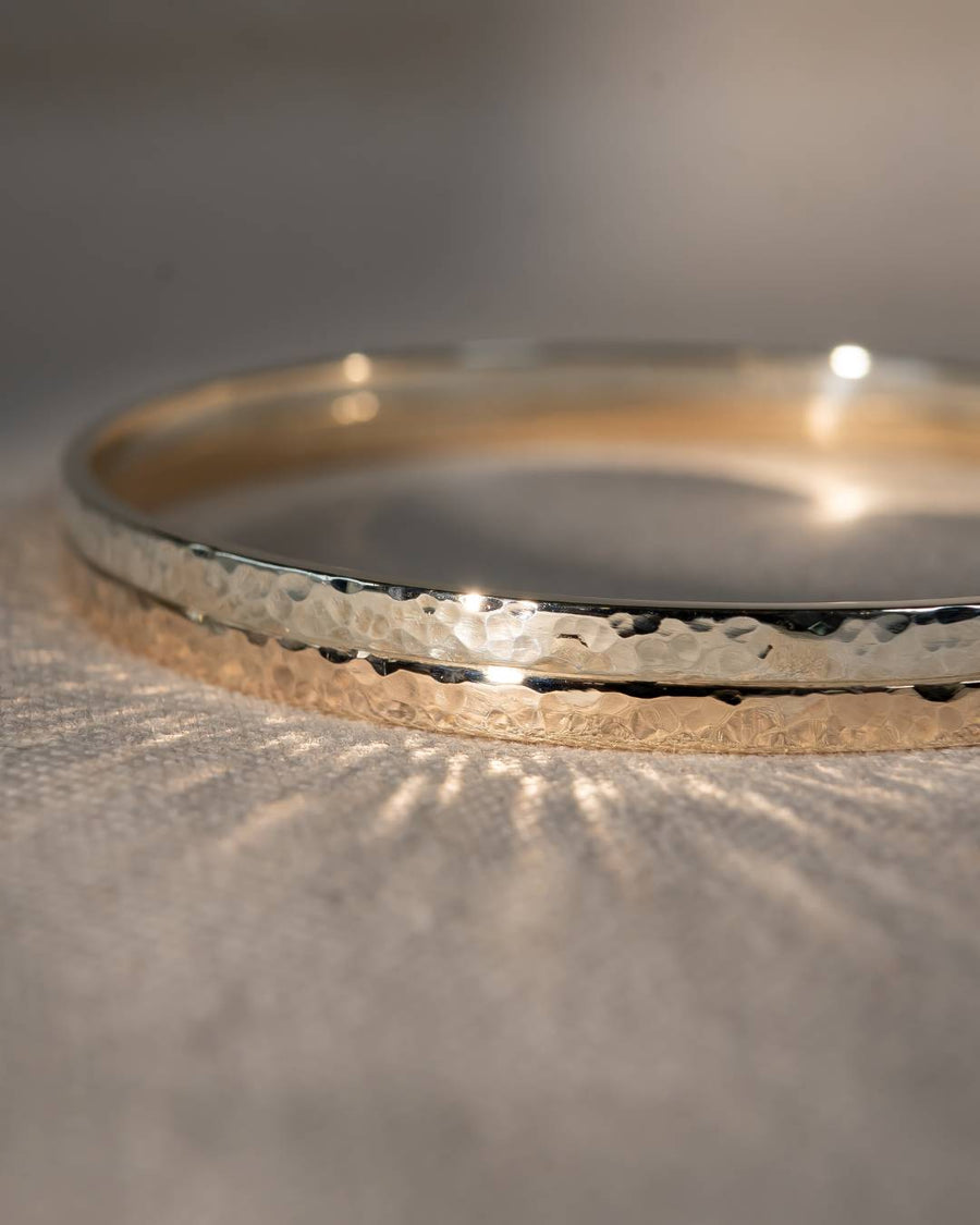 Two tone 9ct gold hammered bangle.