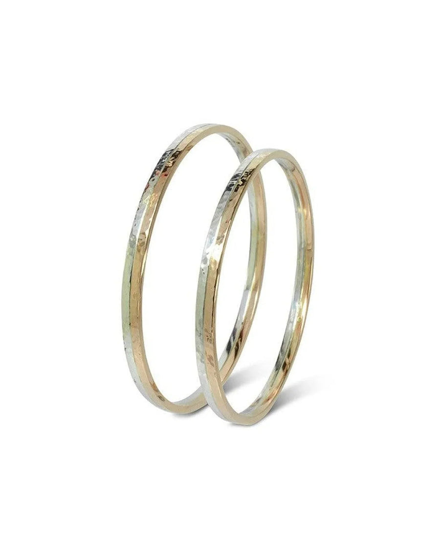 Two 9ct white and yellow gold hammered bangles.