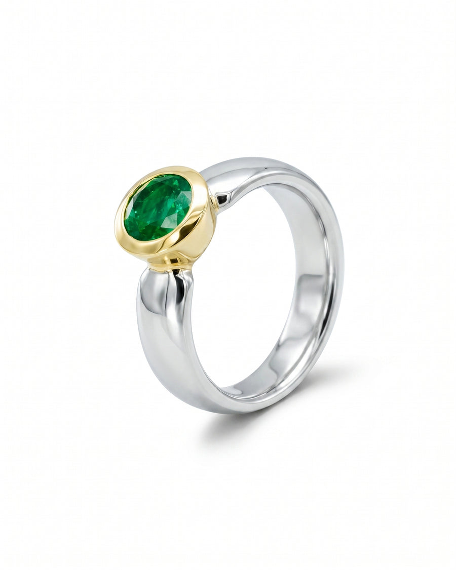 Two-tone gold and silver ring with an oval green gemstone.