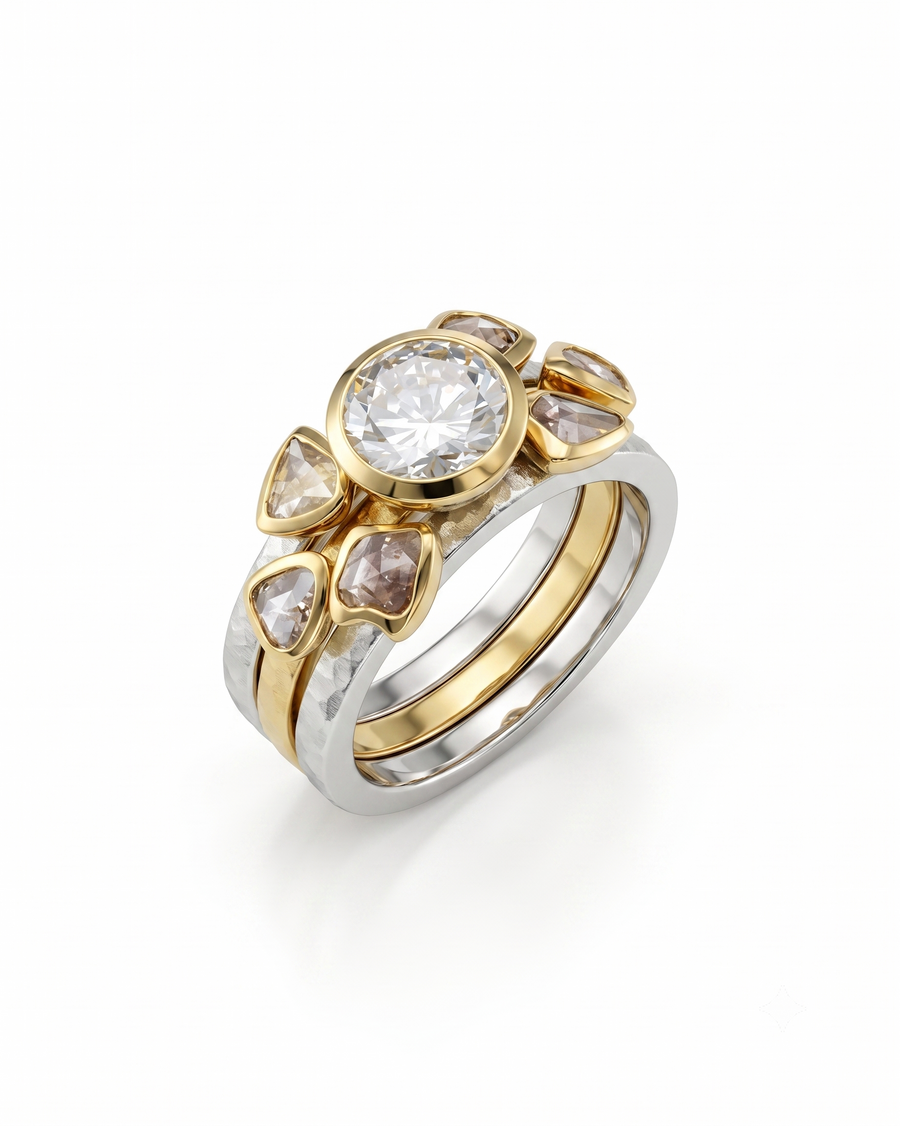 Two-tone gold and silver stacking ring set featuring a round brilliant diamond and rough diamond accents.