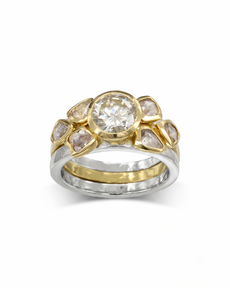 Two-tone gold and silver stacking ring set featuring a round brilliant diamond and rough diamond accents.