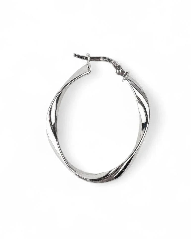 Organic twisted silver hoop earring with uneven shape on white background
