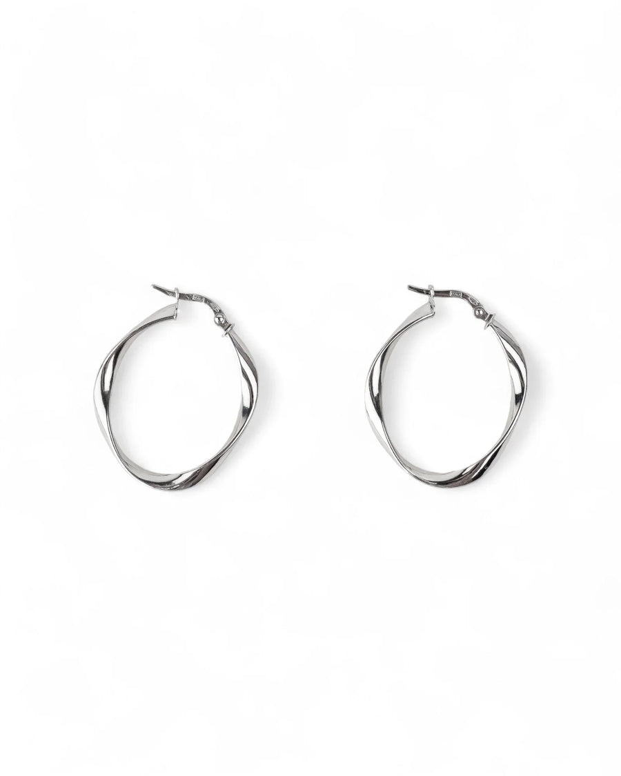 Uneven twisted hoop earrings in polished silver with organic, modern design on white background