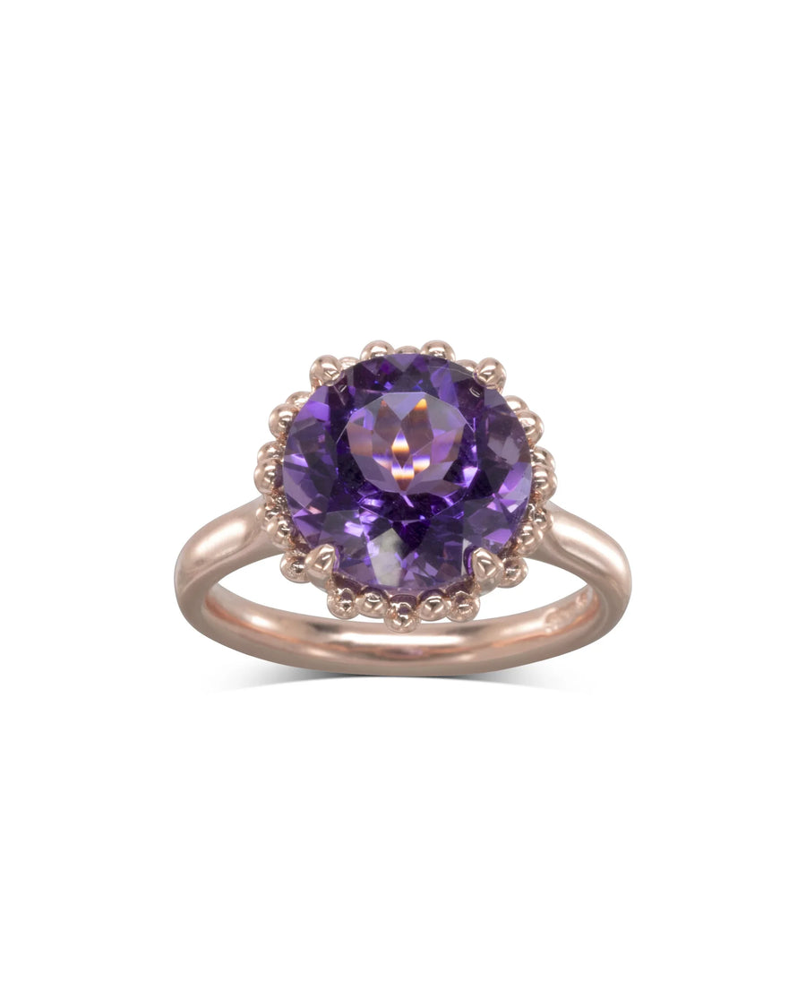 Rose gold ring with large round amethyst gemstone and delicate beaded setting