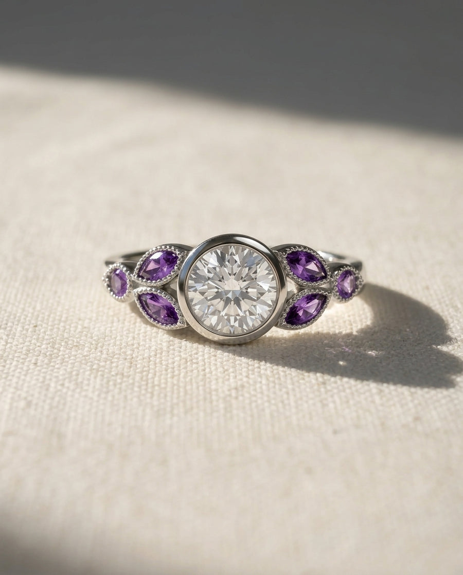Platinum engagement ring with a round diamond and marquise amethyst side stones.